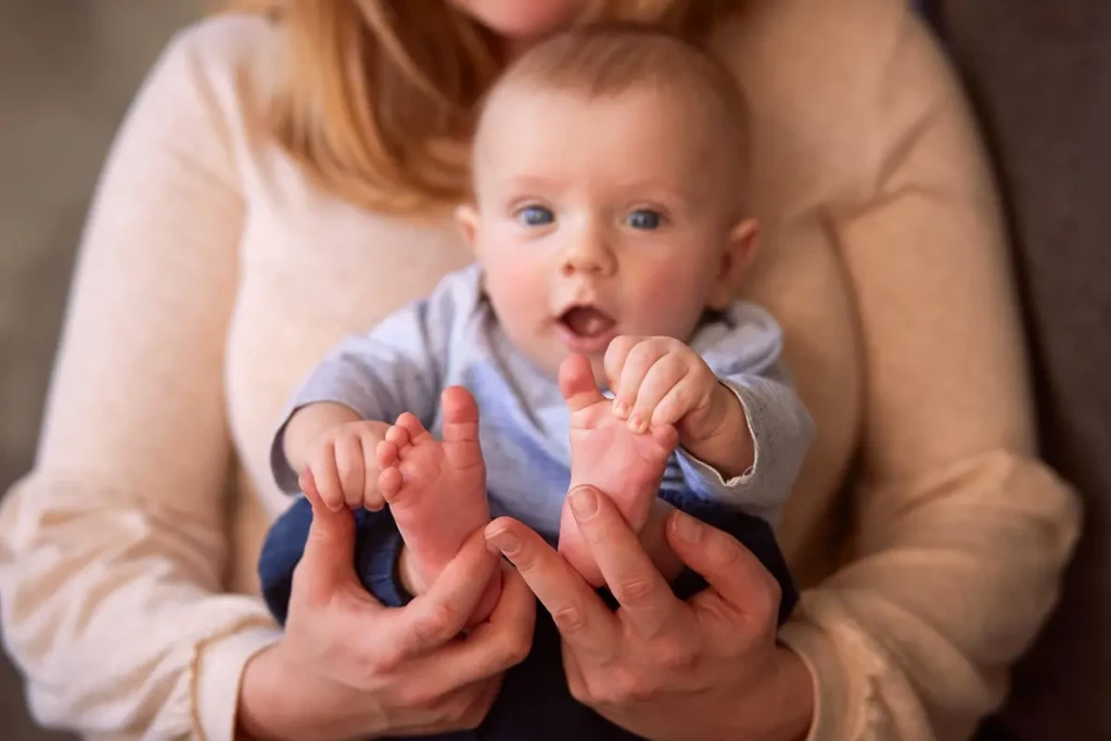 mother-embraces-her-son-sit-window-sill