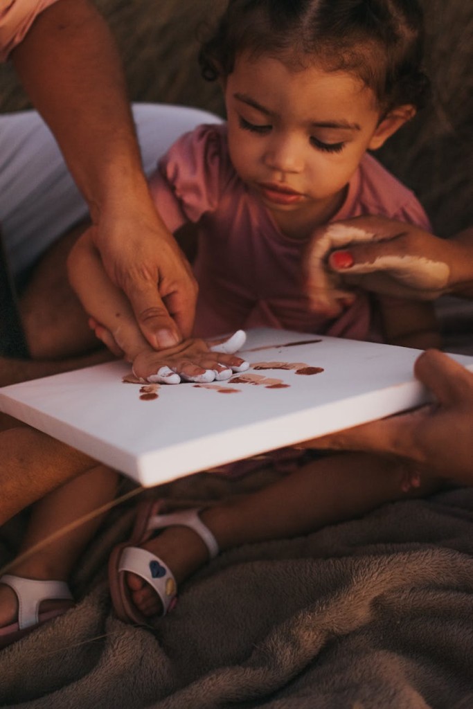 parents helping daughter with painting